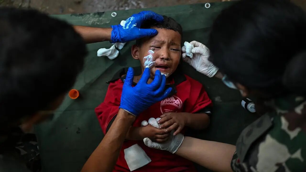 An injured Nepalese child receiving emergency medical care