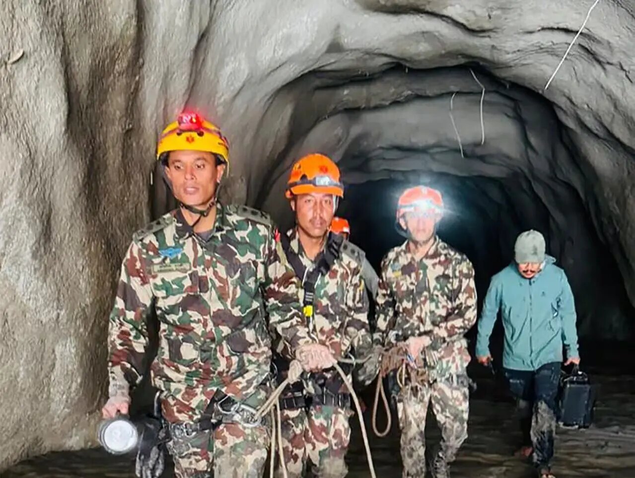 Nepalese rescue personnel conducting a search operation inside a tunnel
